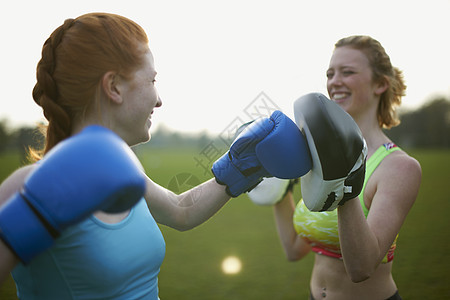 两名妇女在公园里用拳击手套锻炼图片