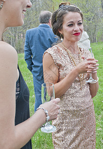 在婚礼上与朋友一起喝酒和交谈的中年成妇女图片