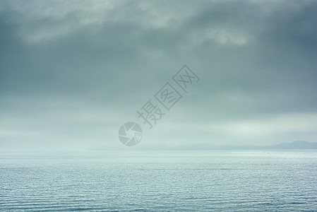 天空暴风雨的在平静水面上看到地平线图片