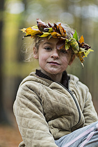戴着秋叶树冠的女孩图片