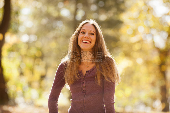 秋林微笑的年轻女性肖像图片