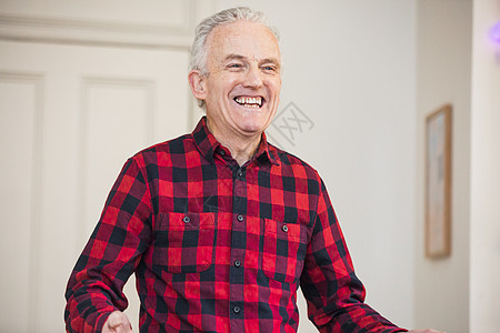 穿着红色上衣衬衫的快乐老年男子肖像图片