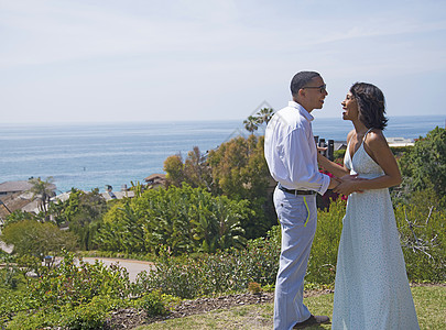 蜜月情侣在加州洛杉矶靠近海洋的山上聊天图片素材