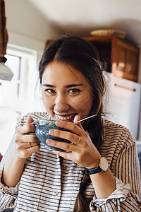 女人拿着茶杯看镜头微笑图片