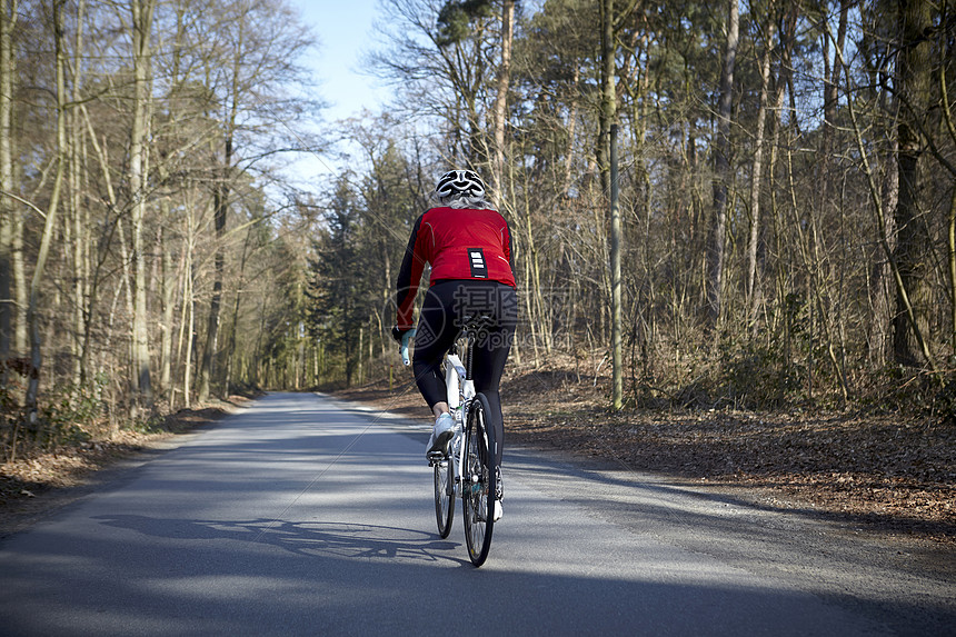 在公路上骑车的女性图片