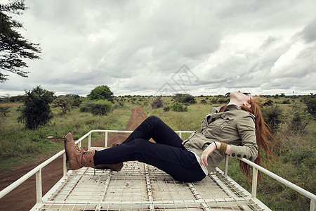 在肯尼亚内罗毕野生公园享受车顶骑的女人图片