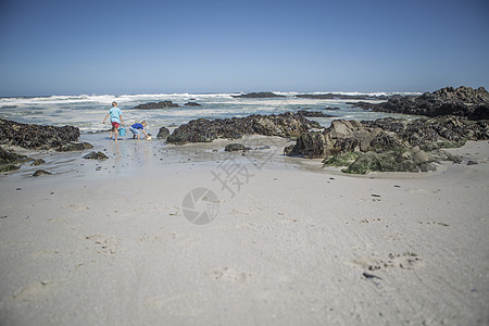 两个男孩在南非开普敦海滩玩水桶图片