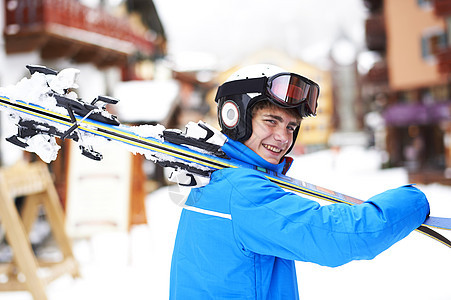 肩扛着滑雪板的少年肖像图片