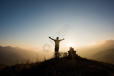 意大利帕索马尼瓦山顶男子举起手臂背影图片