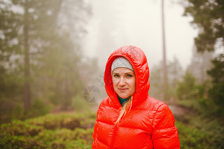美国加利福尼亚州塞科公园穿红色头罩海蓬夹克的妇女图片