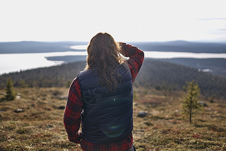 芬兰拉普兰Keimiotunturi湖远足者的背影图片