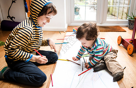 男幼儿和大哥坐在地板上长纸画图片