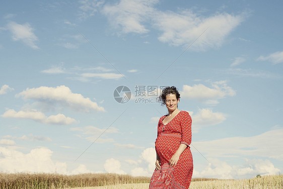 蓝天下麦田里的孕妇图片