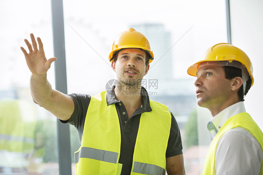 在新建办公空间进行讨论的两名男子图片