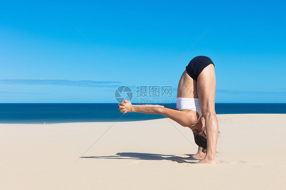 女人在海滩的侧面弯曲前方的瑜伽姿势图片