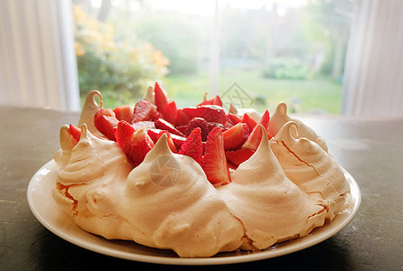 盘子上的梅林瓜和草莓甜点特配图片