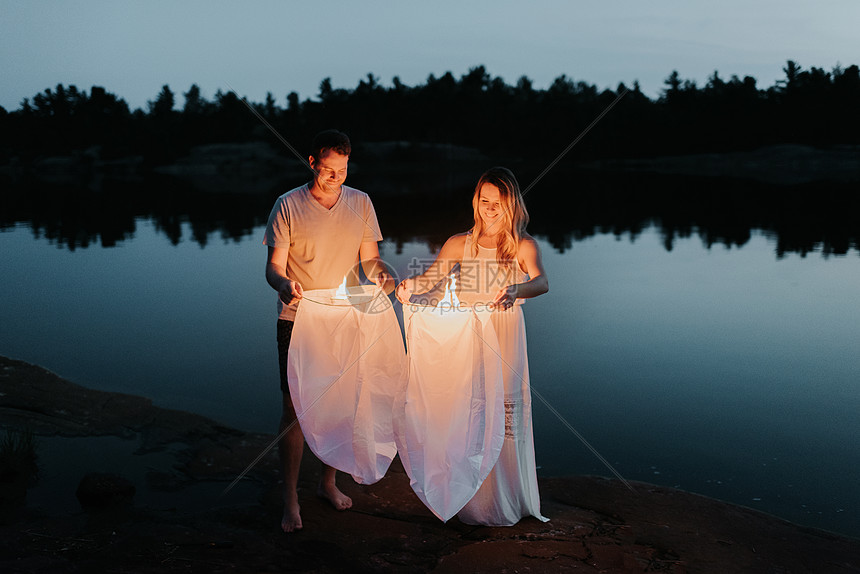 一对夫妇在加拿大Algonquin公园湖边放天灯图片