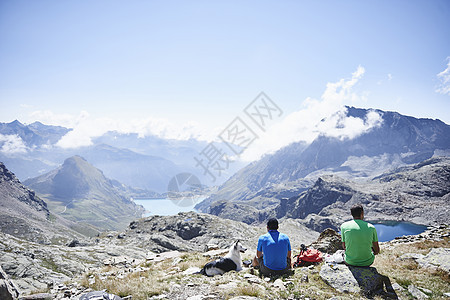 瑞士瓦莱州登山者朋友坐在岩石上休息图片