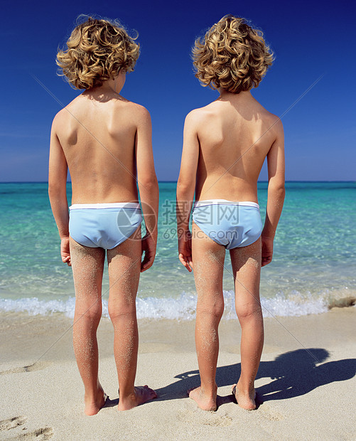二个男孩站在海边图片