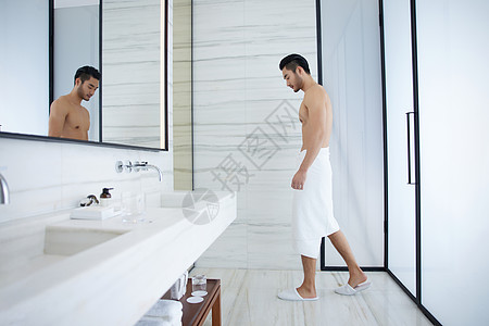 裹浴巾走出洗手间的成熟男士图片
