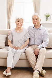 坐着微笑彩色图片幸福的老年夫妇在客厅图片