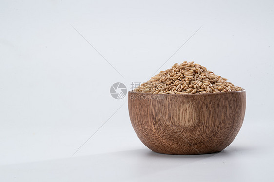 养生粮食木碗装满燕麦米图片