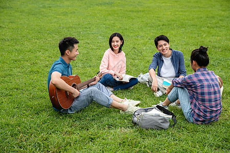 友谊绿色交流快乐的大学生在草地上弹吉他唱歌图片