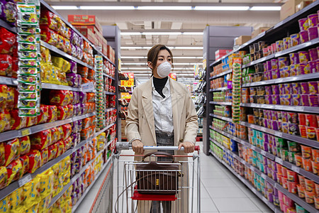 预防新型冠状预防戴口罩的青年女人在超市购物图片