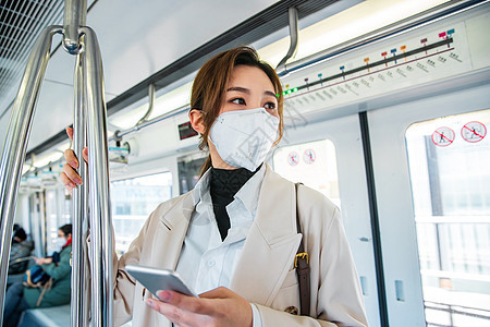 空气污染雾霾戴口罩的年轻女人站在地铁里图片