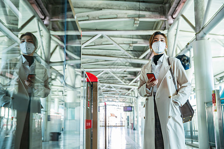 疫情戴口罩的年轻女人站在地铁站台上图片