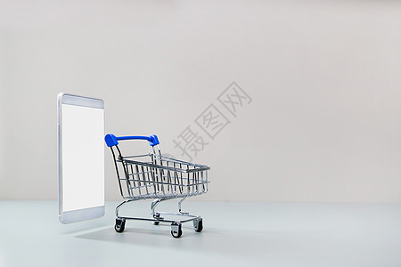 现代经济网上购物手机和迷你购物车背景图片