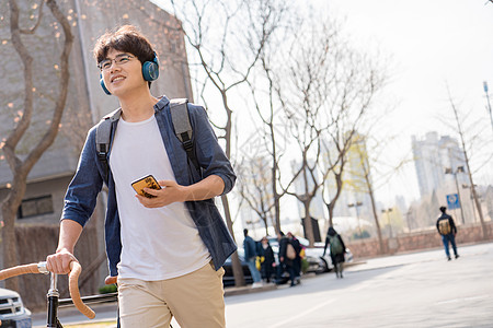 青年文化大学生在校园里骑自行车图片