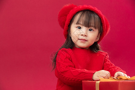 节日红色儿童可爱的小女孩拿着新年礼物图片