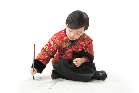 气氛亚洲人举小男孩盘腿坐着拿毛笔写字图片