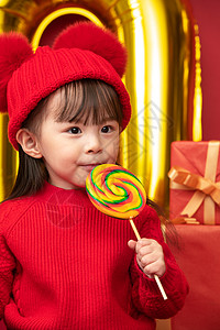 节日甜食传统庆典过新年的小女孩吃棒棒糖图片