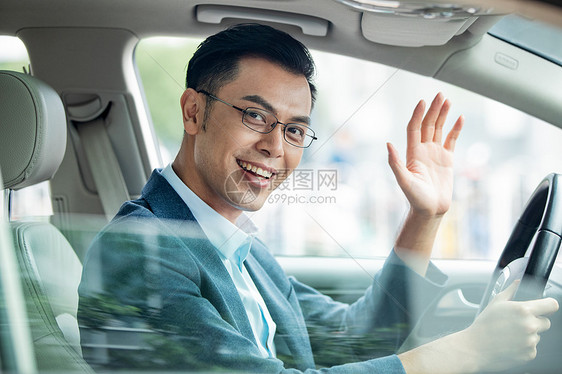 通勤商务男士坐在汽车里打招呼图片