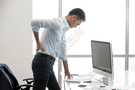 办公室内腰疼的商务男士图片