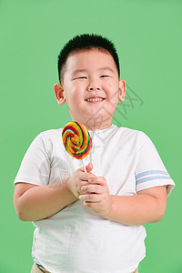 东方人摄影食品可爱的小男孩拿着棒棒糖图片