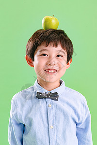 小男孩头上顶着一个苹果图片