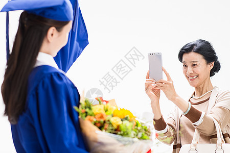大学毕业幸福快乐的母女用手机拍照图片