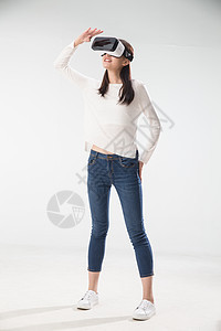 虚拟现实模拟器表现积极白昼戴着VR眼镜的青年女人图片