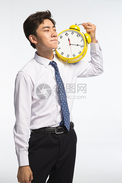 亚洲时间仅男人商务青年男人拿着闹钟图片