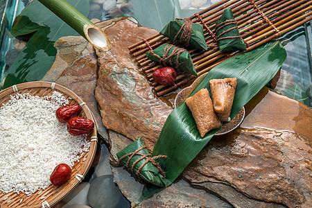 竹筒粽流水下的糯米红枣粽和肉粽背景