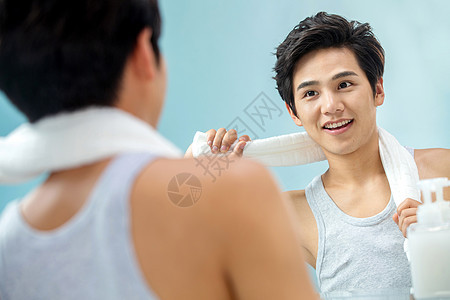 活力影棚拍摄亚洲人自信的年轻男人挂着毛巾照镜子图片