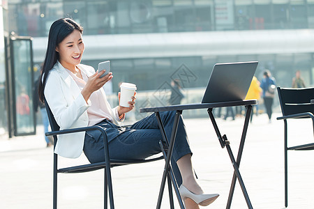 城市青年人拍摄环境手机青年商务女士在户外工作背景