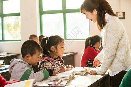 可爱的志愿者少量人群乡村女教师和小学生在教室里图片