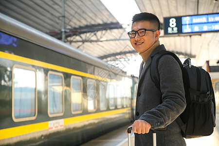 旅行白昼等青年男人在车站月台图片