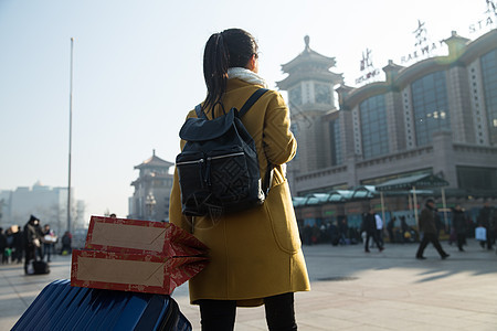 乘客北京旅行箱青年女人在站前广场图片