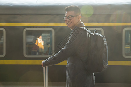 仅一个青年男人旅行箱仅男人青年男人在车站月台背景图片