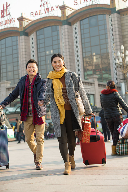 春节摄影旅行者青年男女在站前广场图片